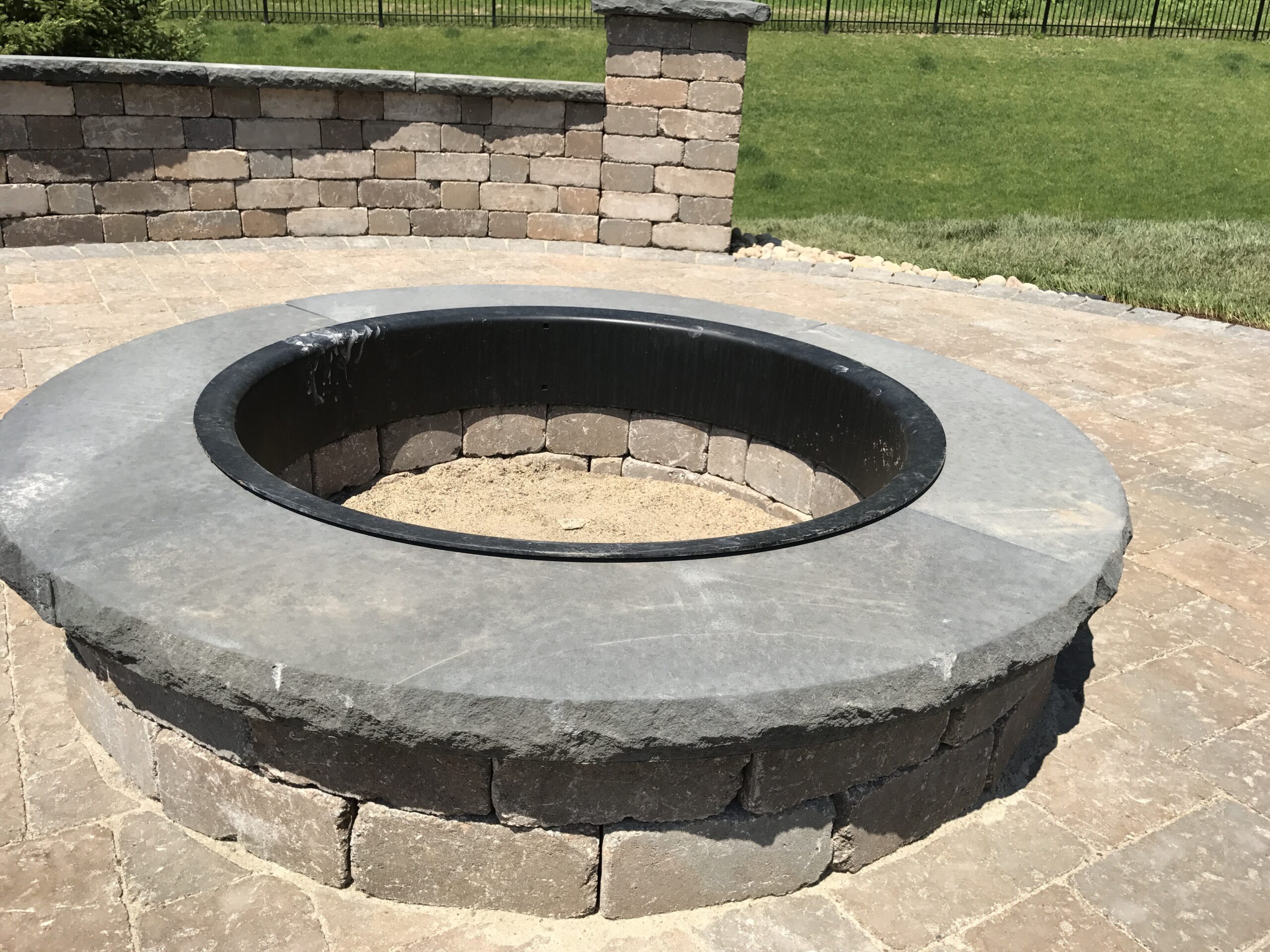 Patio and fire pit project by North Ridge Outdoor Services
