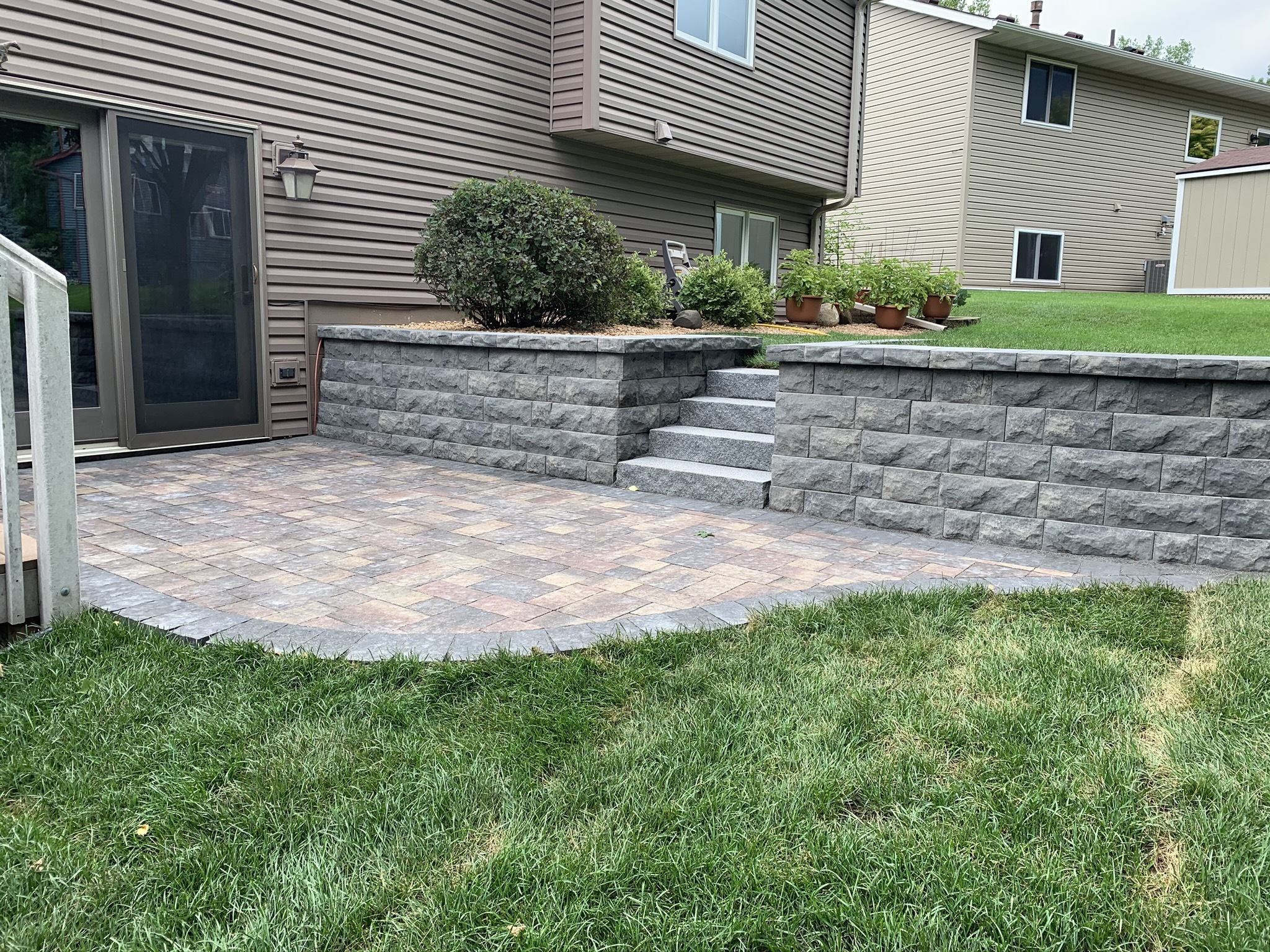 Patio and fire pit project by North Ridge Outdoor Services