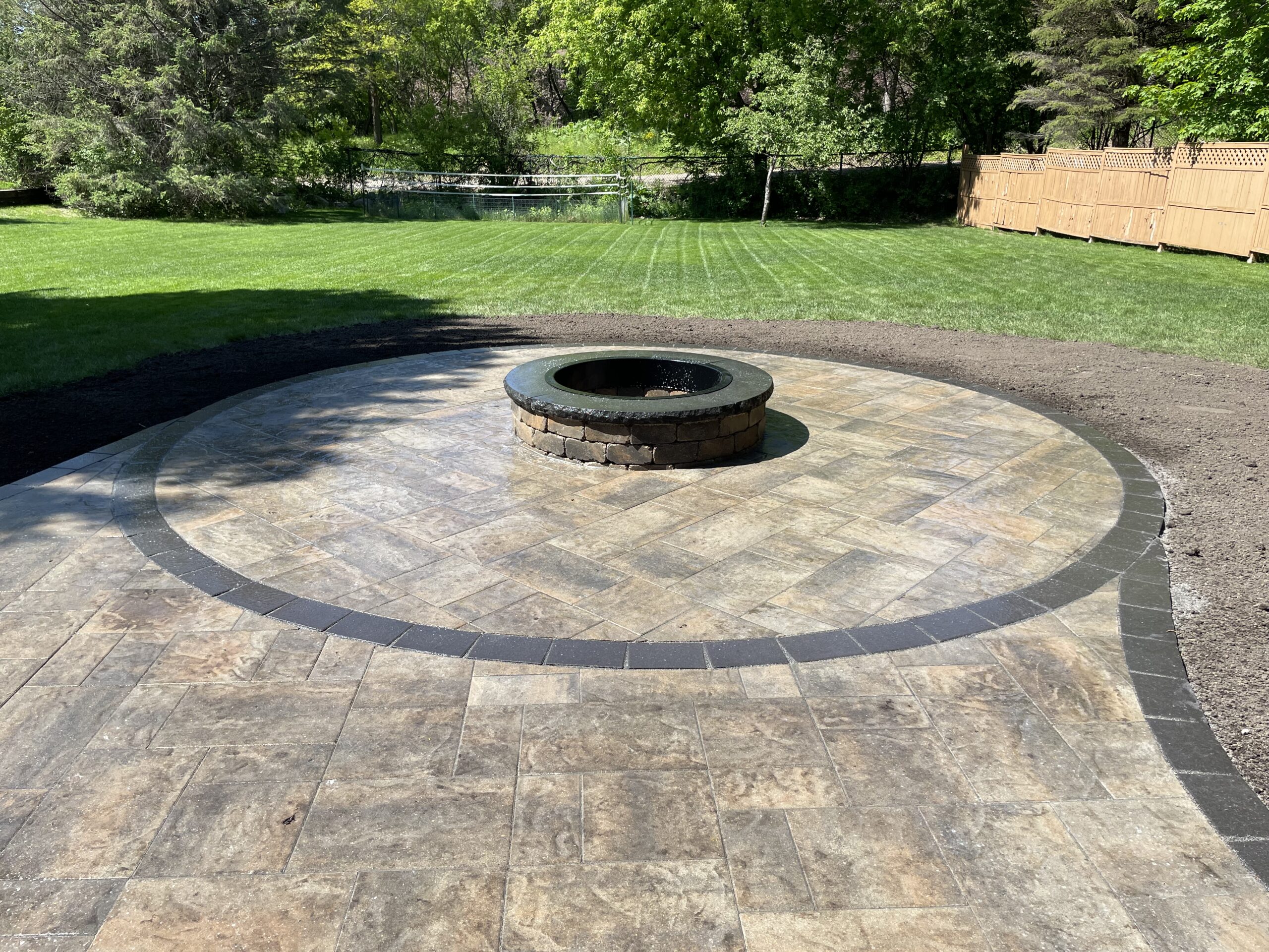Patio and fire pit project by North Ridge Outdoor Services