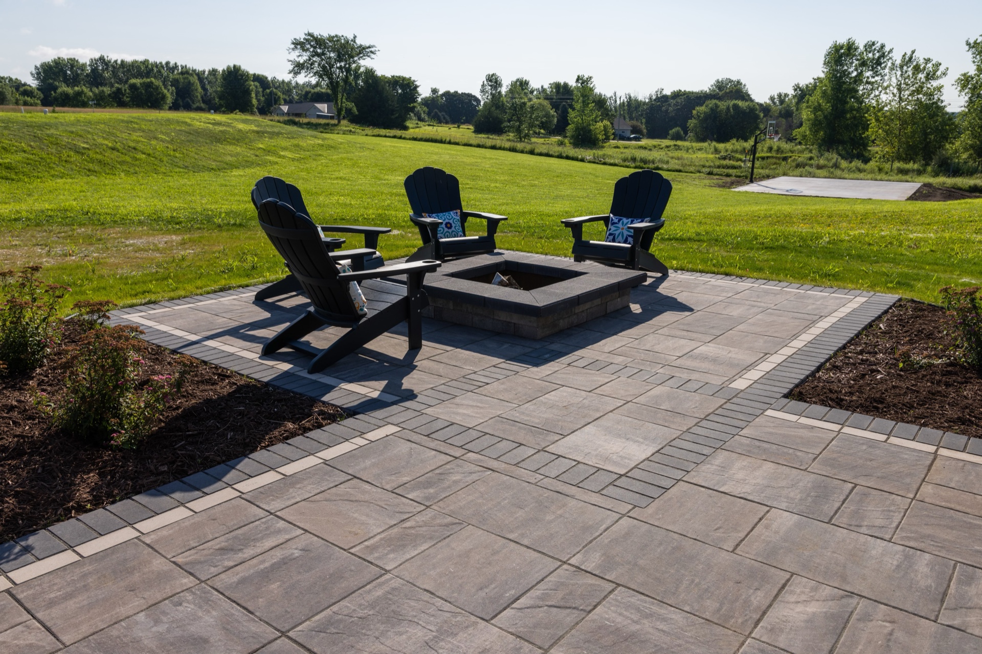 Custom backyard landscape design at the Prescott residence with paver patio and plantings